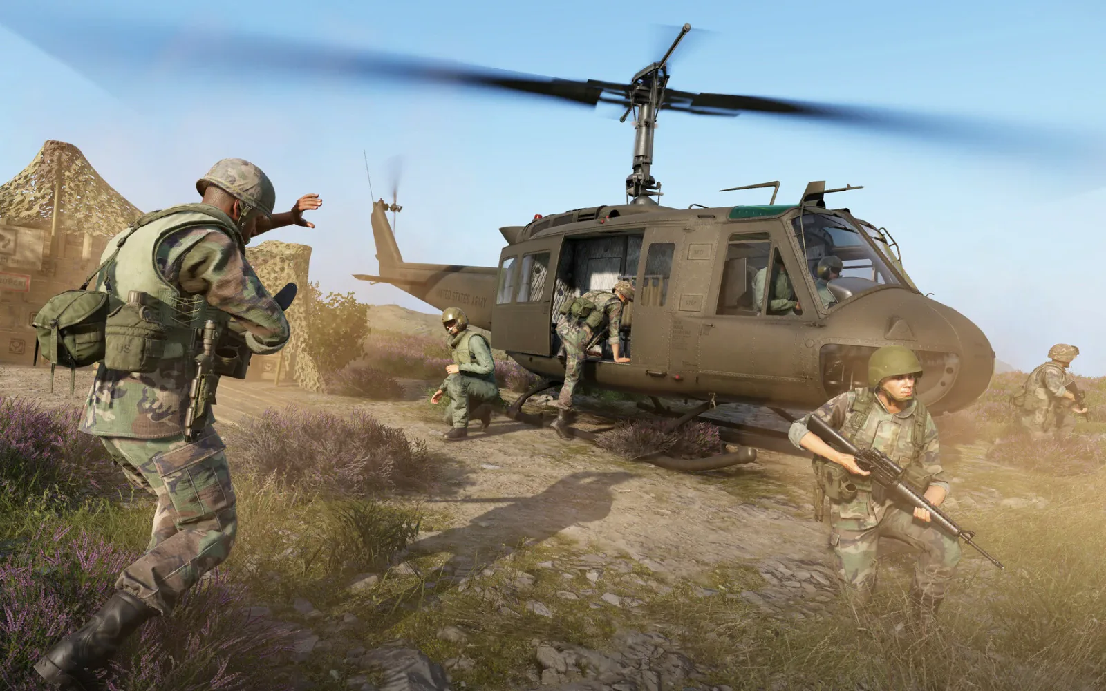 A squad disembarks from a UH-1 helicopter in Arma Reforger