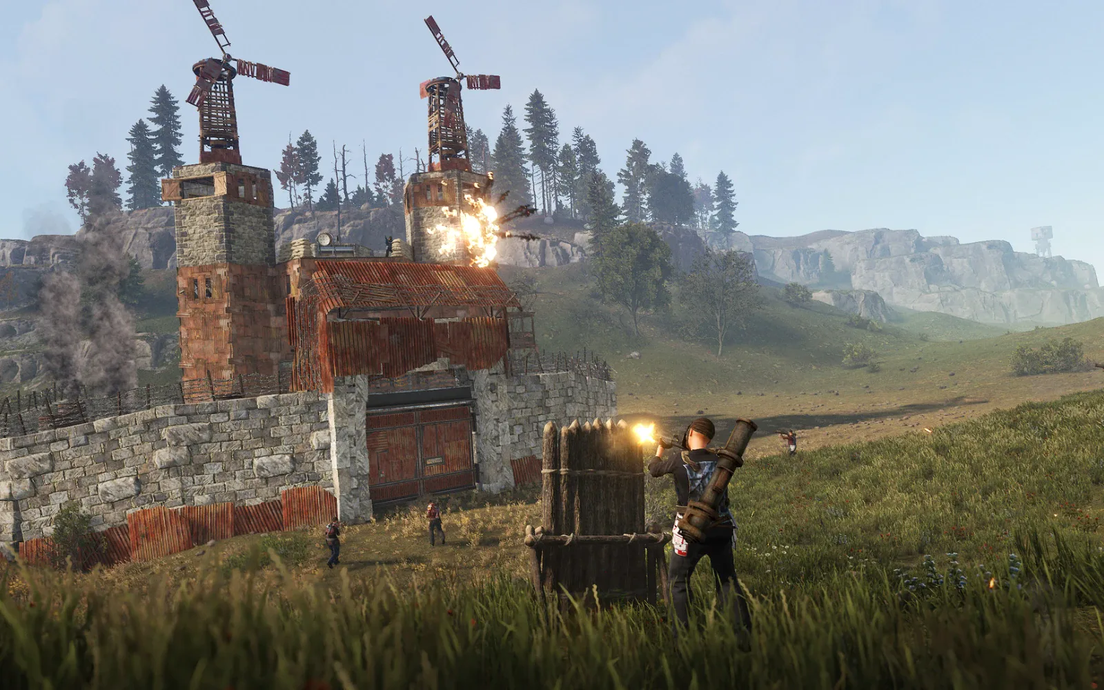A fortified base with windmills under attack in Rust